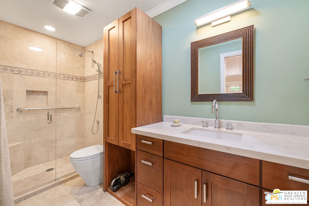 1115 East Alejo Road Palm Springs, CA 92262 - Photo 28 of 40 a bathroom with a sink a toilet and shower