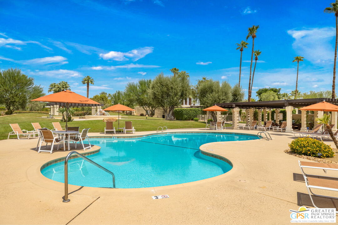 1115 East Alejo Road Palm Springs, CA 92262 - Photo 29 of 40 a view of a swimming pool with chairs