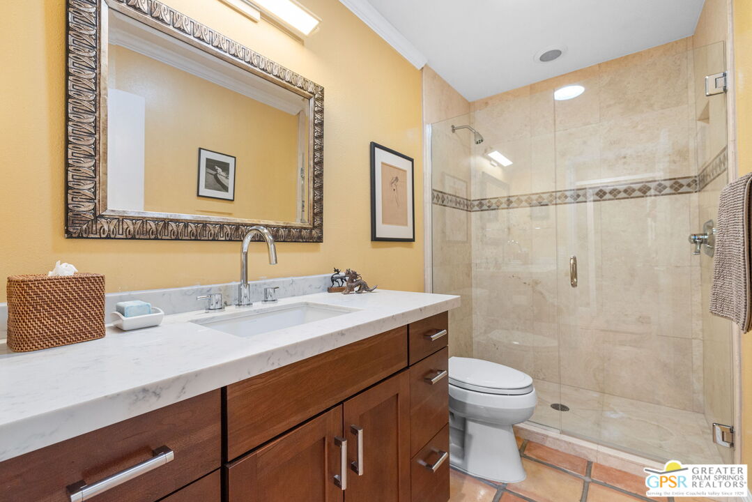 1115 East Alejo Road Palm Springs, CA 92262 - Photo 33 of 40 a bathroom with a sink a toilet and shower