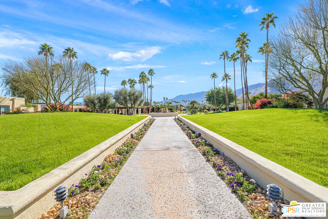 1115 East Alejo Road Palm Springs, CA 92262 - Photo 36 of 40 a view of a garden with a bench