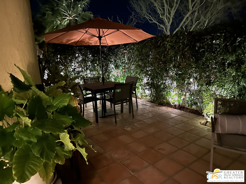 1115 East Alejo Road Palm Springs, CA 92262 - Photo 39 of 40 a view of backyard with table and chairs under an umbrella