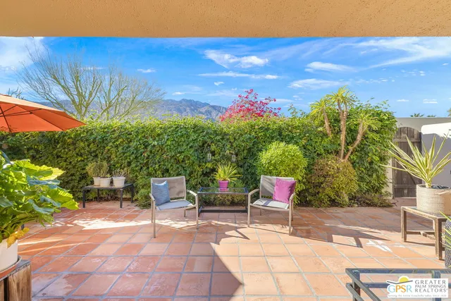 a view of a chairs and table in the patio