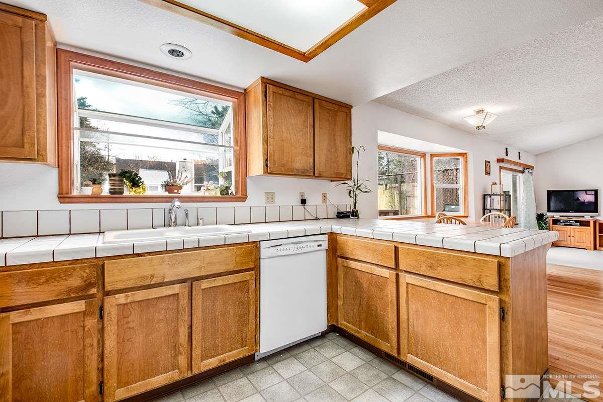 1635 Peavine Road Reno, NV 89503 - Photo 5 of 25 a kitchen with white cabinets and sink