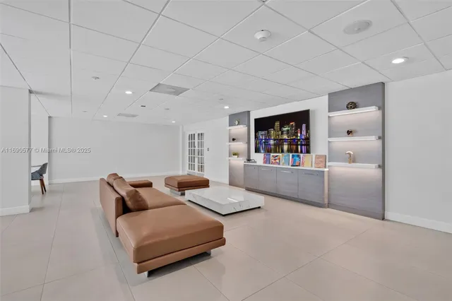 a living room with furniture and a book shelf