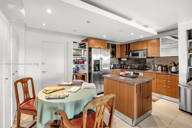 a kitchen that has a table and chairs in it