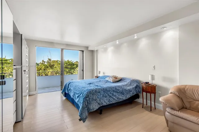 a spacious bedroom with a bed and a couch