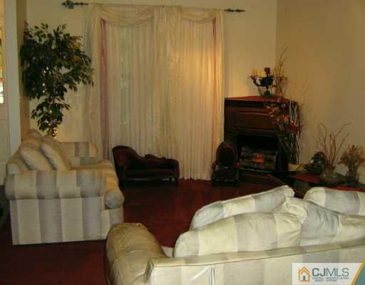 51 Rainford Road Edison, NJ 08820 - Photo 2 of 8 a living room with furniture and a fireplace