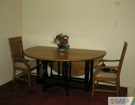 51 Rainford Road Edison, NJ 08820 - Photo 3 of 8 a view of a dining room with furniture and wooden floor