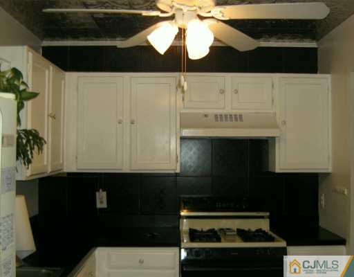 51 Rainford Road Edison, NJ 08820 - Photo 4 of 8 a kitchen with a stove and a microwave