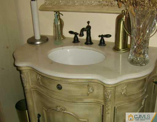 51 Rainford Road Edison, NJ 08820 - Photo 7 of 8 a bathroom with a sink and mirror