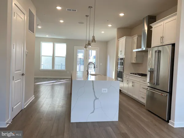 a kitchen with stainless steel appliances a refrigerator sink and cabinets