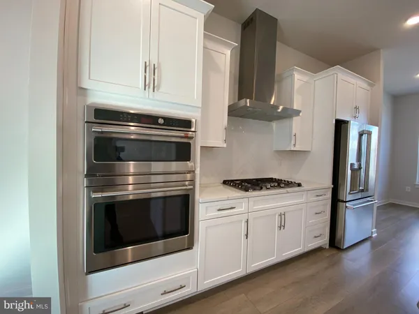 a kitchen with stainless steel appliances white cabinets and a stove