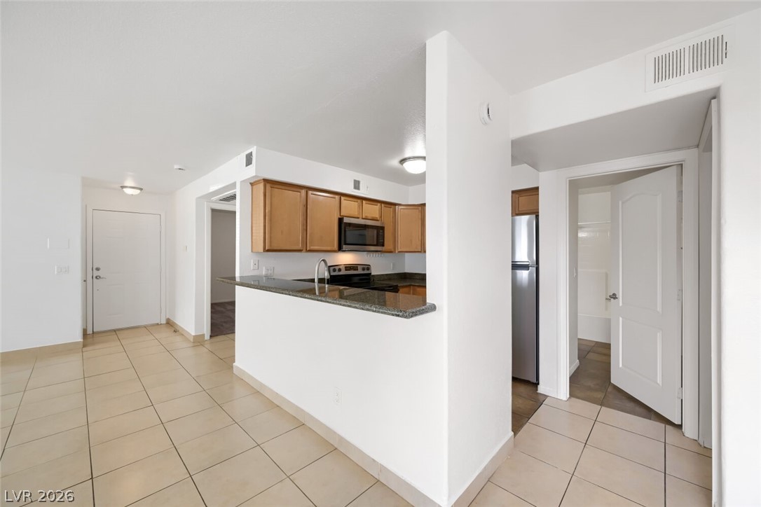 9325 West Desert Inn Road, Unit 177 Las Vegas, NV 89117 - Photo 7 of 24 Granite counters and stainless steel appliances complete this compact, functional kitchen.