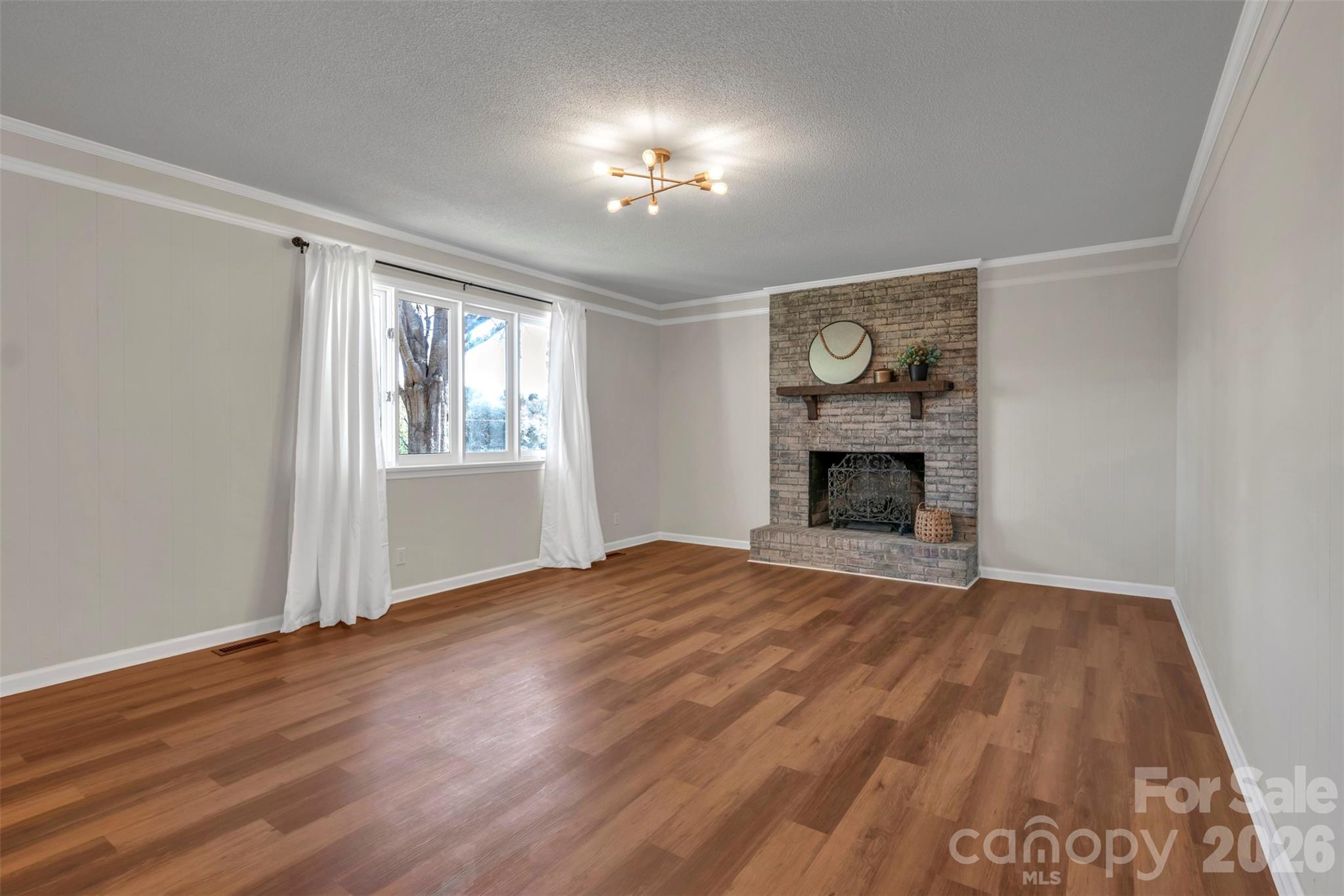 1471 Monroe Highway Lancaster, SC 29720 - Photo 11 of 45 a view of an empty room with wooden floor fireplace and a window