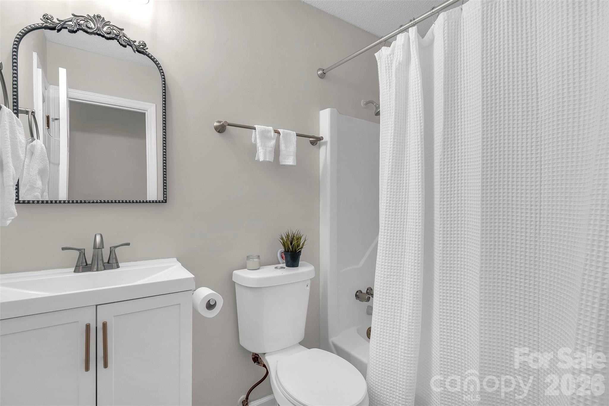 1471 Monroe Highway Lancaster, SC 29720 - Photo 31 of 45 a bathroom with a toilet a sink and a mirror