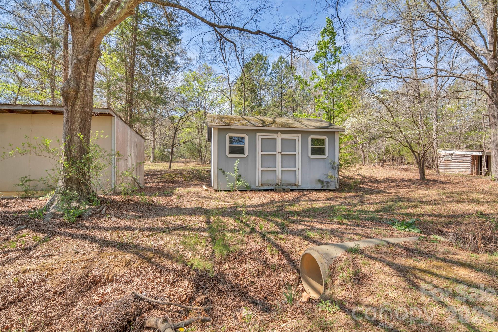 1471 Monroe Highway Lancaster, SC 29720 - Photo 45 of 45 a backyard of a house with large trees and barbeque oven