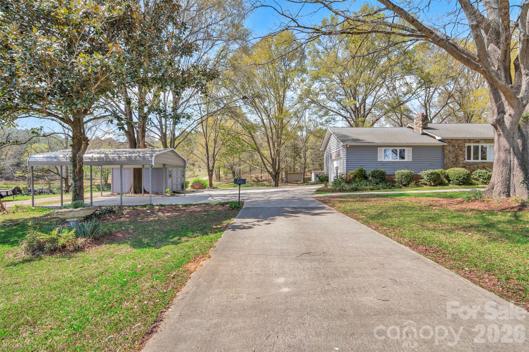 1471 Monroe Highway Lancaster, SC 29720 - Photo 9 of 45 a front view of a house with a garden and trees