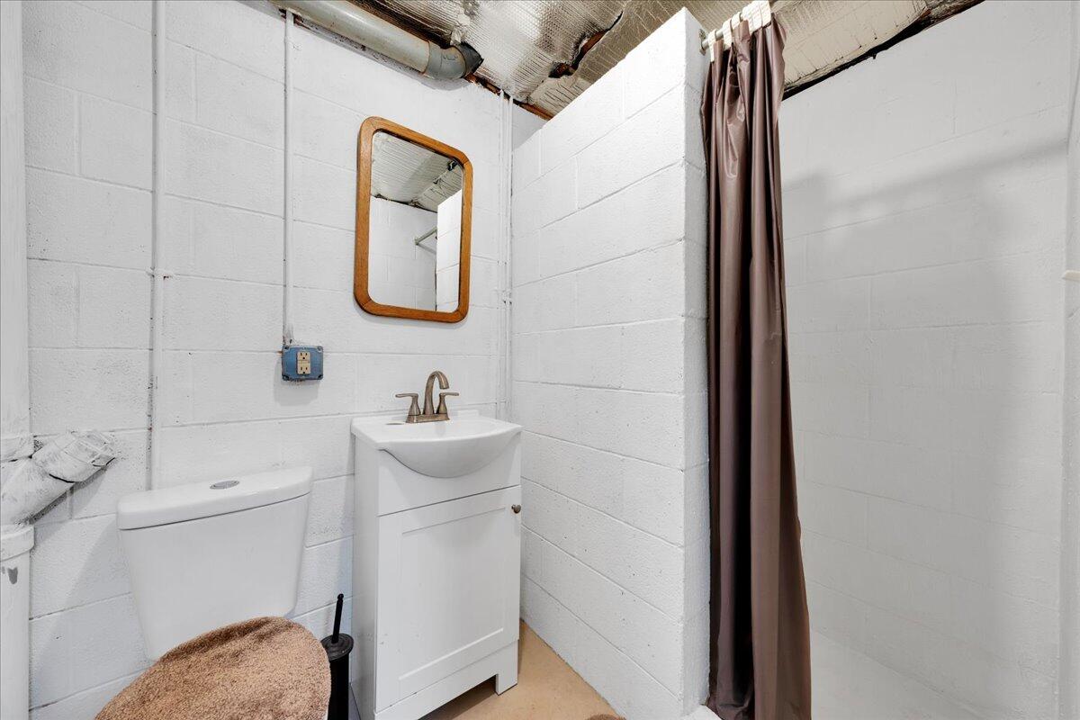4660 Franklin Street Rocky Mount, VA 24151 - Photo 28 of 55 a bathroom with a toilet sink vanity and mirror