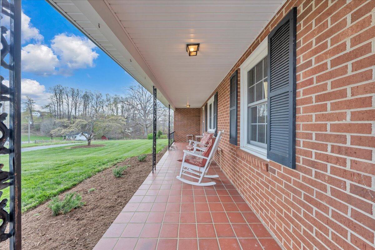 4660 Franklin Street Rocky Mount, VA 24151 - Photo 4 of 55 a view of a chair and tables in the patio next to a yard