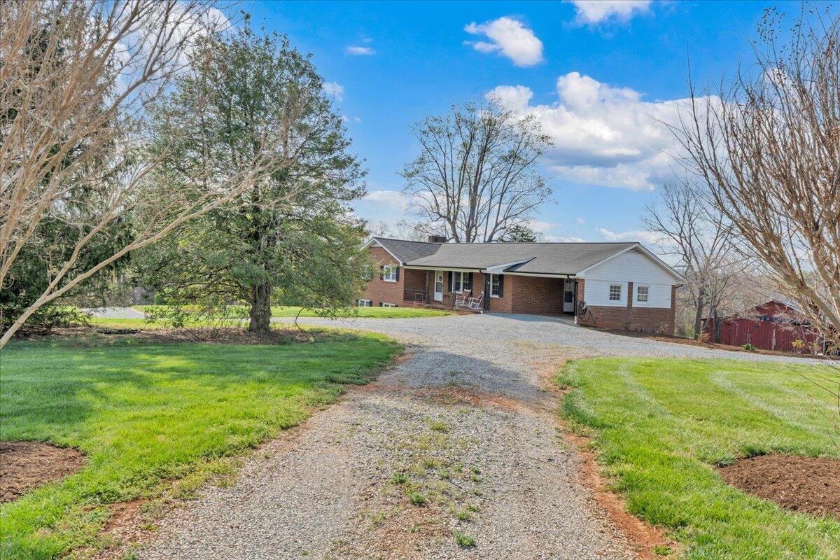 4660 Franklin Street Rocky Mount, VA 24151 - Photo 51 of 55 a front view of a house with a garden and trees