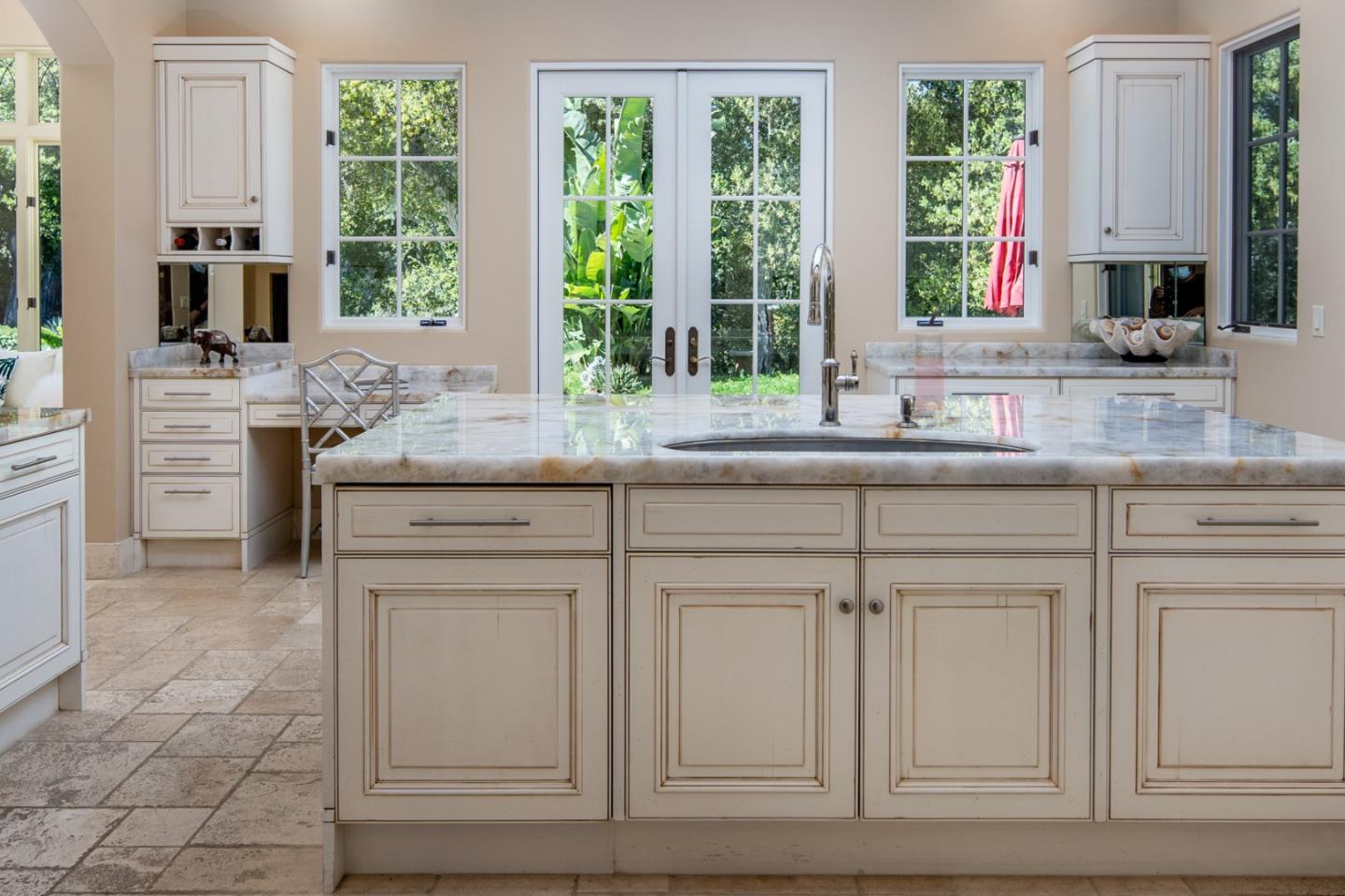 24316 Monterra Woods Monterey, CA 93940 - Photo 14 of 31 a kitchen with white cabinets and a large window