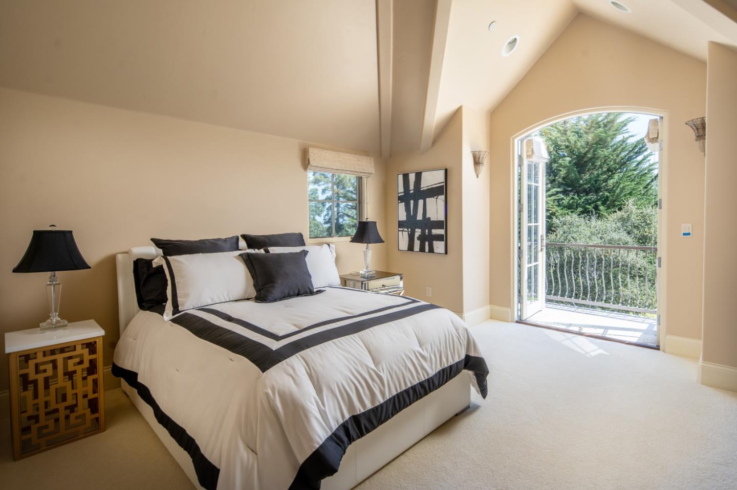 24316 Monterra Woods Monterey, CA 93940 - Photo 24 of 31 a bedroom with a bed and a large window