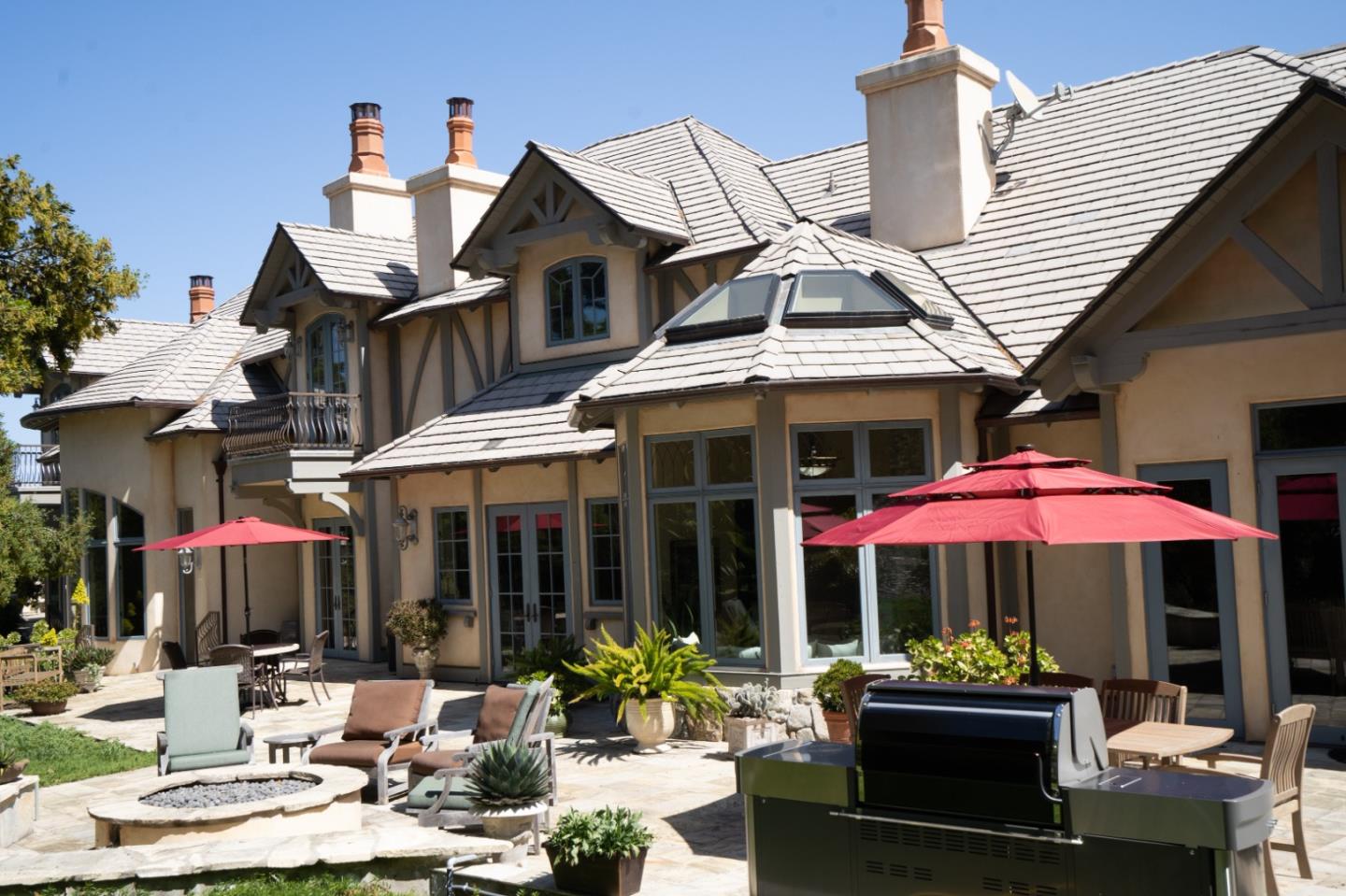 24316 Monterra Woods Monterey, CA 93940 - Photo 26 of 31 a patio with a table and chairs under an umbrella