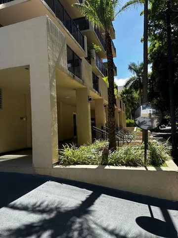 a view of a back yard of the house and cars parked