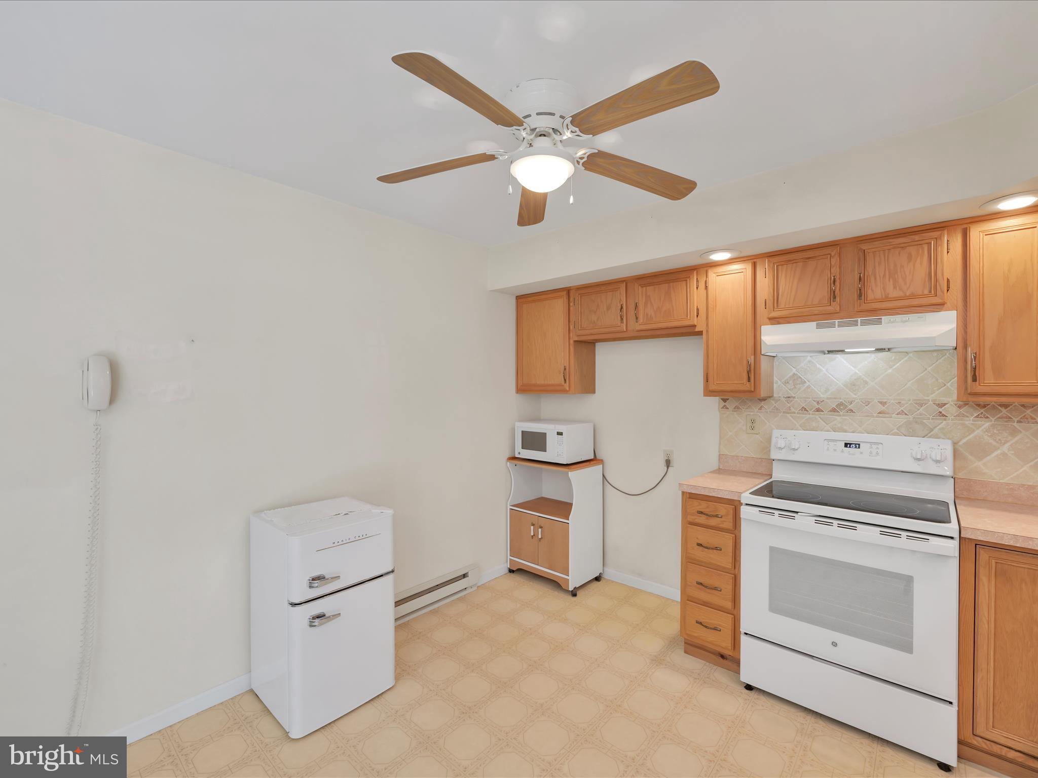 95 Comanche Drive Auburn, PA 17922 - Photo 12 of 33 a kitchen with white cabinets and white appliances