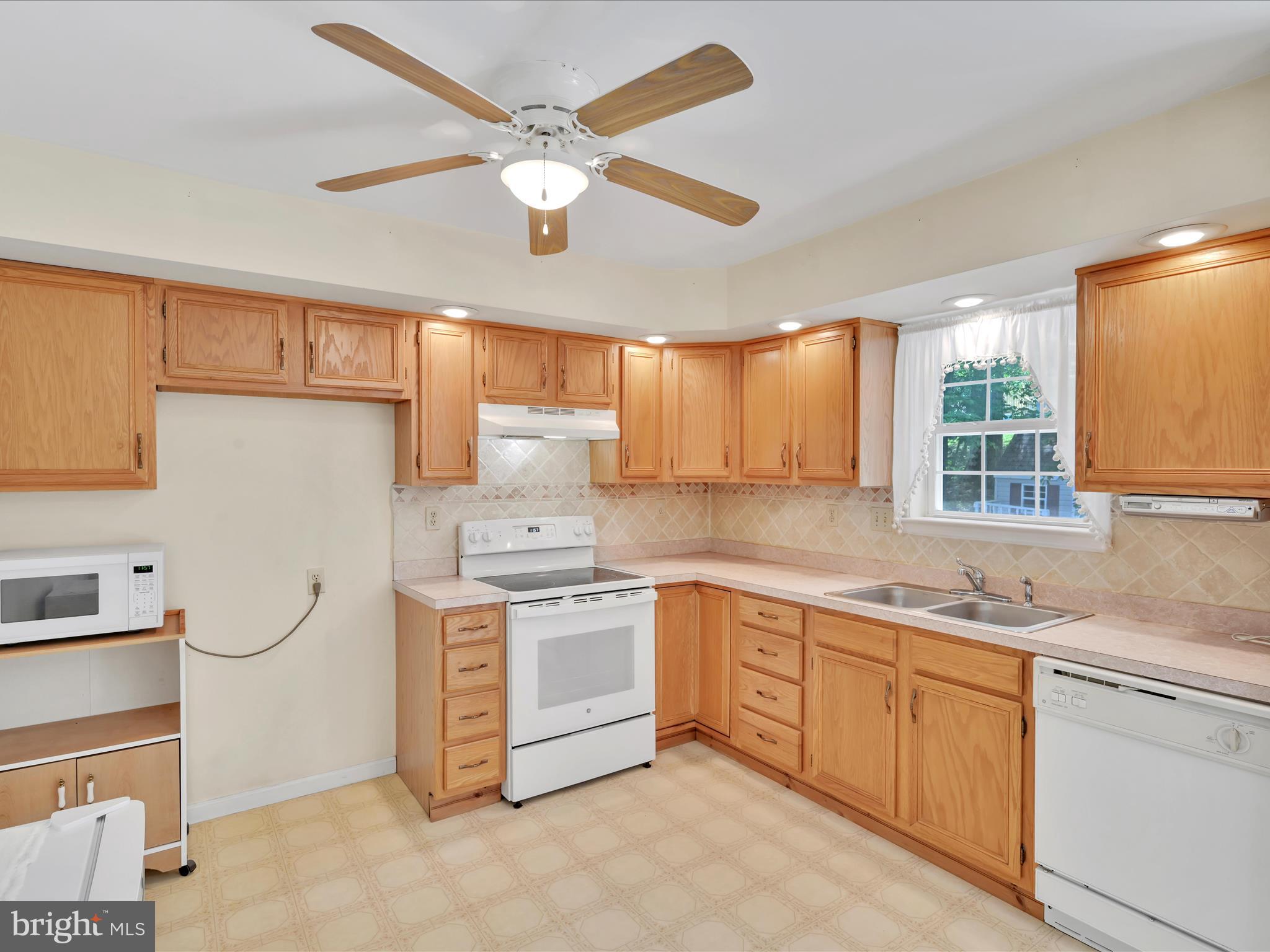 95 Comanche Drive Auburn, PA 17922 - Photo 13 of 33 a kitchen with stainless steel appliances granite countertop a stove sink and cabinets