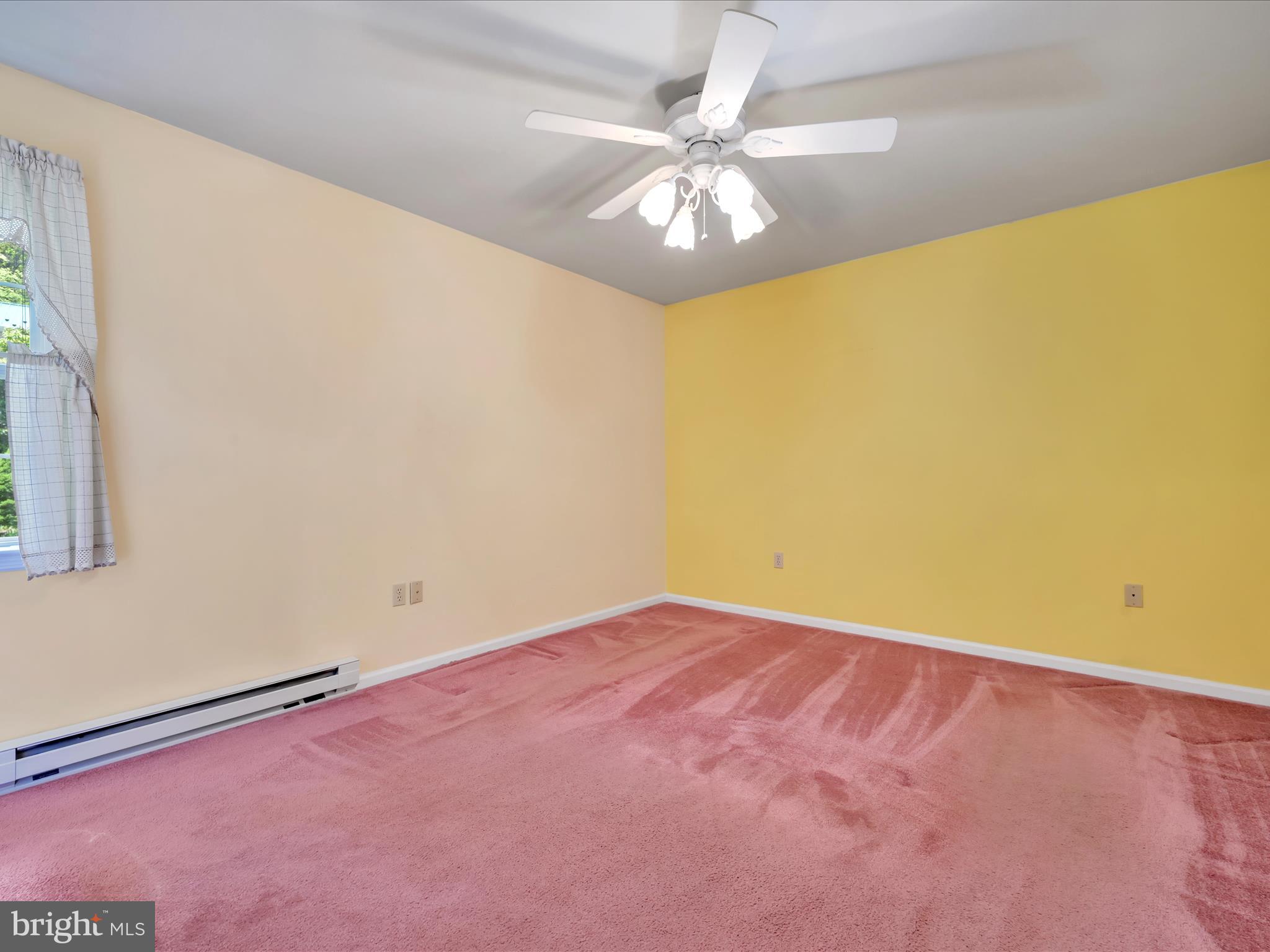 95 Comanche Drive Auburn, PA 17922 - Photo 16 of 33 an empty room with a chandelier fan and windows
