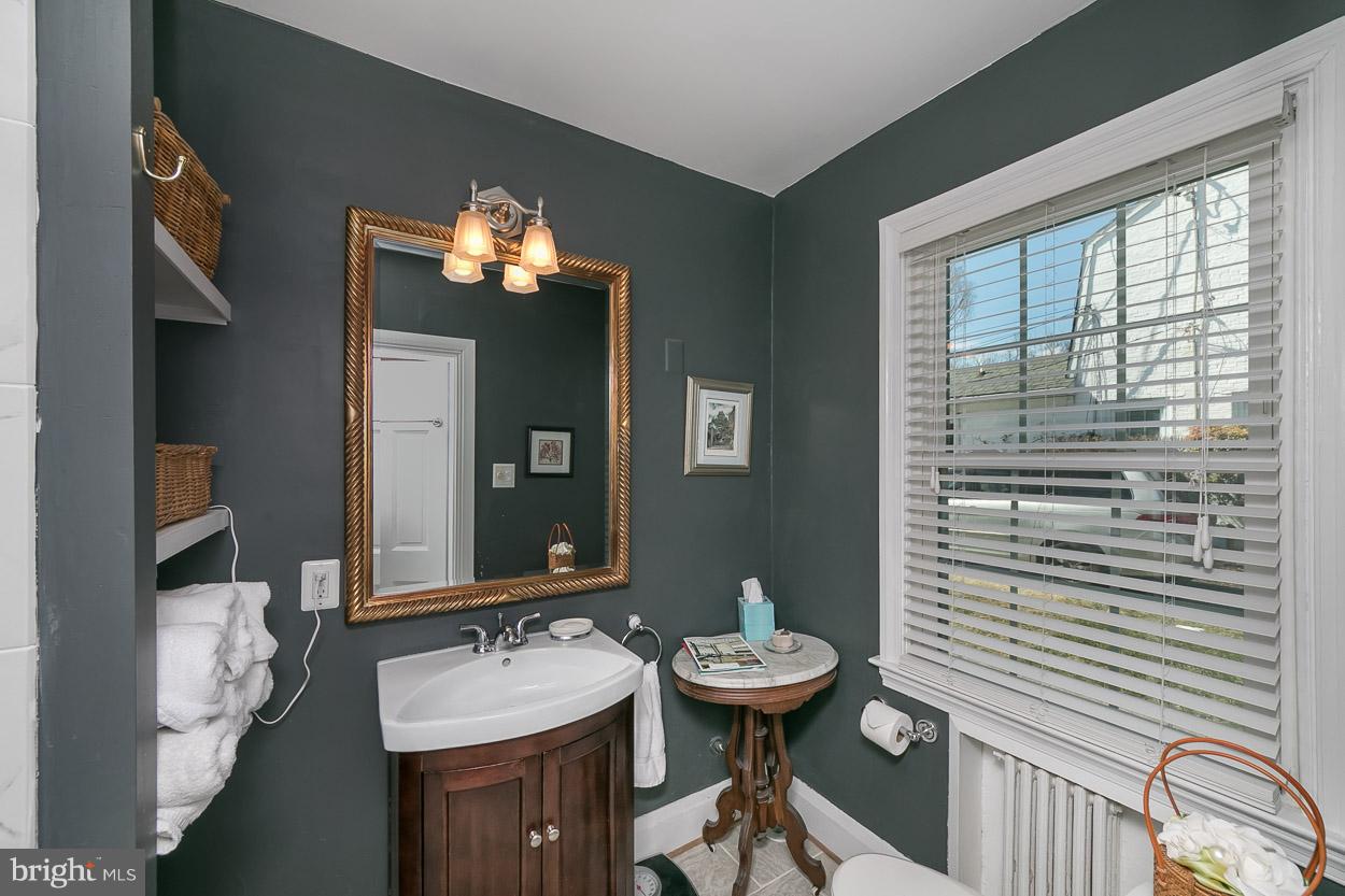 513 Wilton Road Baltimore, MD 21286 - Photo 21 of 30 a bathroom with a sink and a mirror