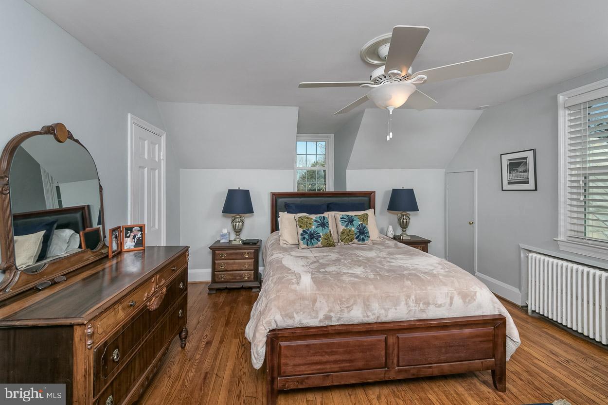 513 Wilton Road Baltimore, MD 21286 - Photo 23 of 30 a bedroom with a bed and wooden floor