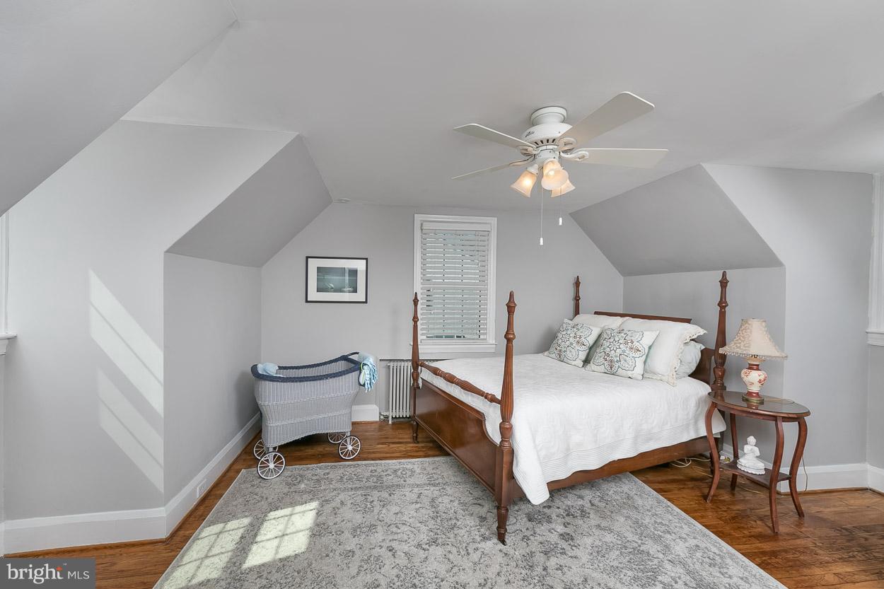 513 Wilton Road Baltimore, MD 21286 - Photo 24 of 30 a bedroom with a bed and a chandelier