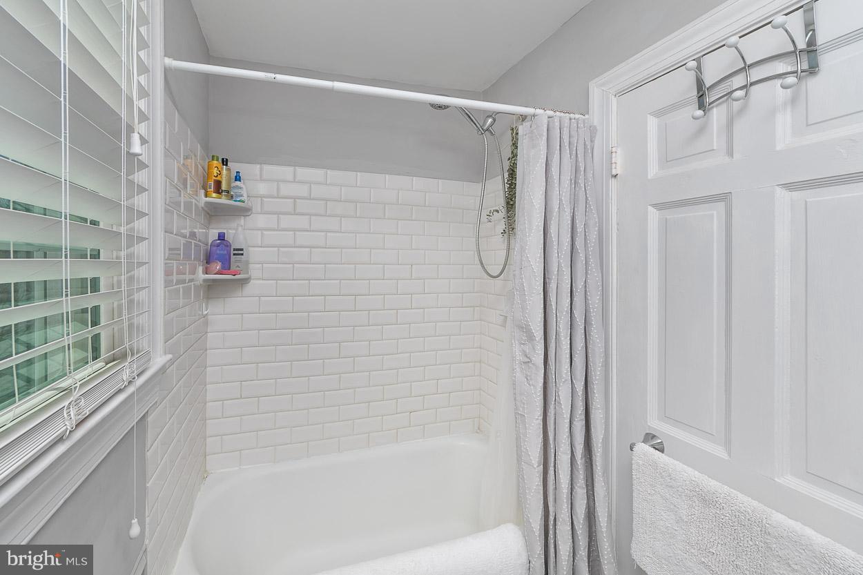 513 Wilton Road Baltimore, MD 21286 - Photo 26 of 30 a bathroom with a shower and a tub