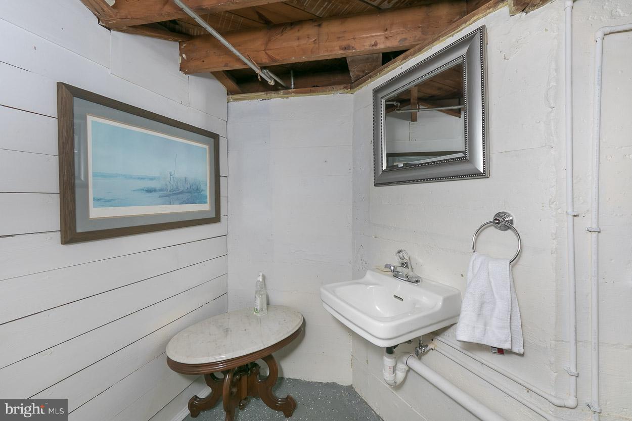 513 Wilton Road Baltimore, MD 21286 - Photo 30 of 30 a bathroom with a toilet a sink and mirror