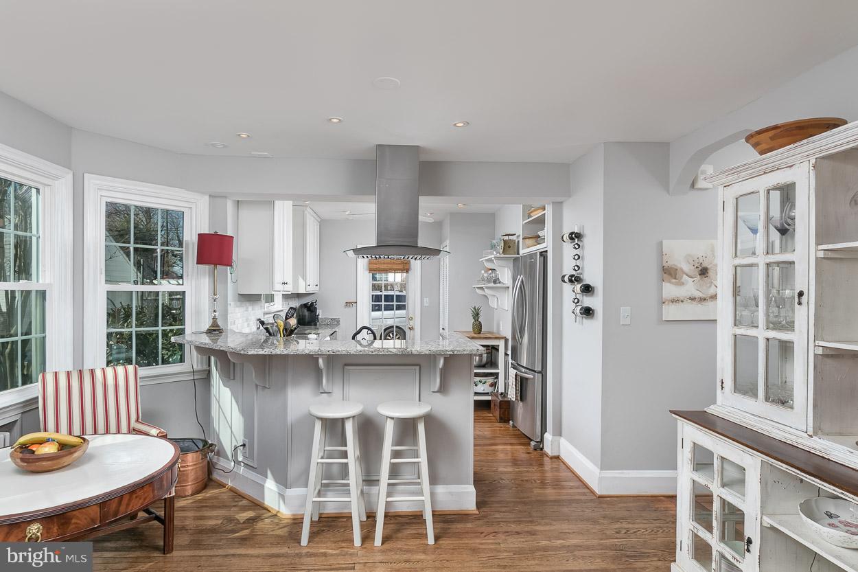 513 Wilton Road Baltimore, MD 21286 - Photo 10 of 30 a kitchen with a dining table chairs and refrigerator