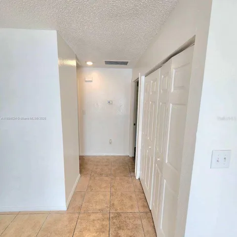 a view of a hallway with wooden shelves