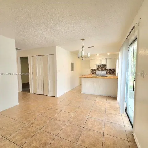 a view of a kitchen with a sink and a refrigerator