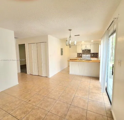a view of a kitchen with wooden floor and stainless steel appliances