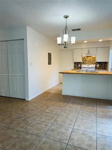 a view of a kitchen with a sink stainless steel appliances and cabinets