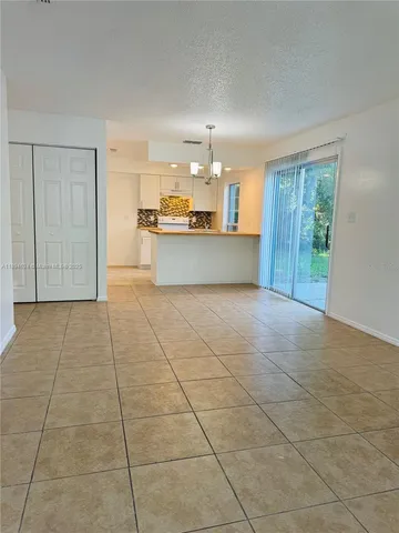 a view of kitchen with granite countertop cabinets
