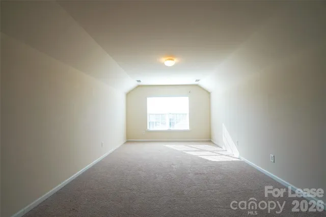 a view of an empty room and a window