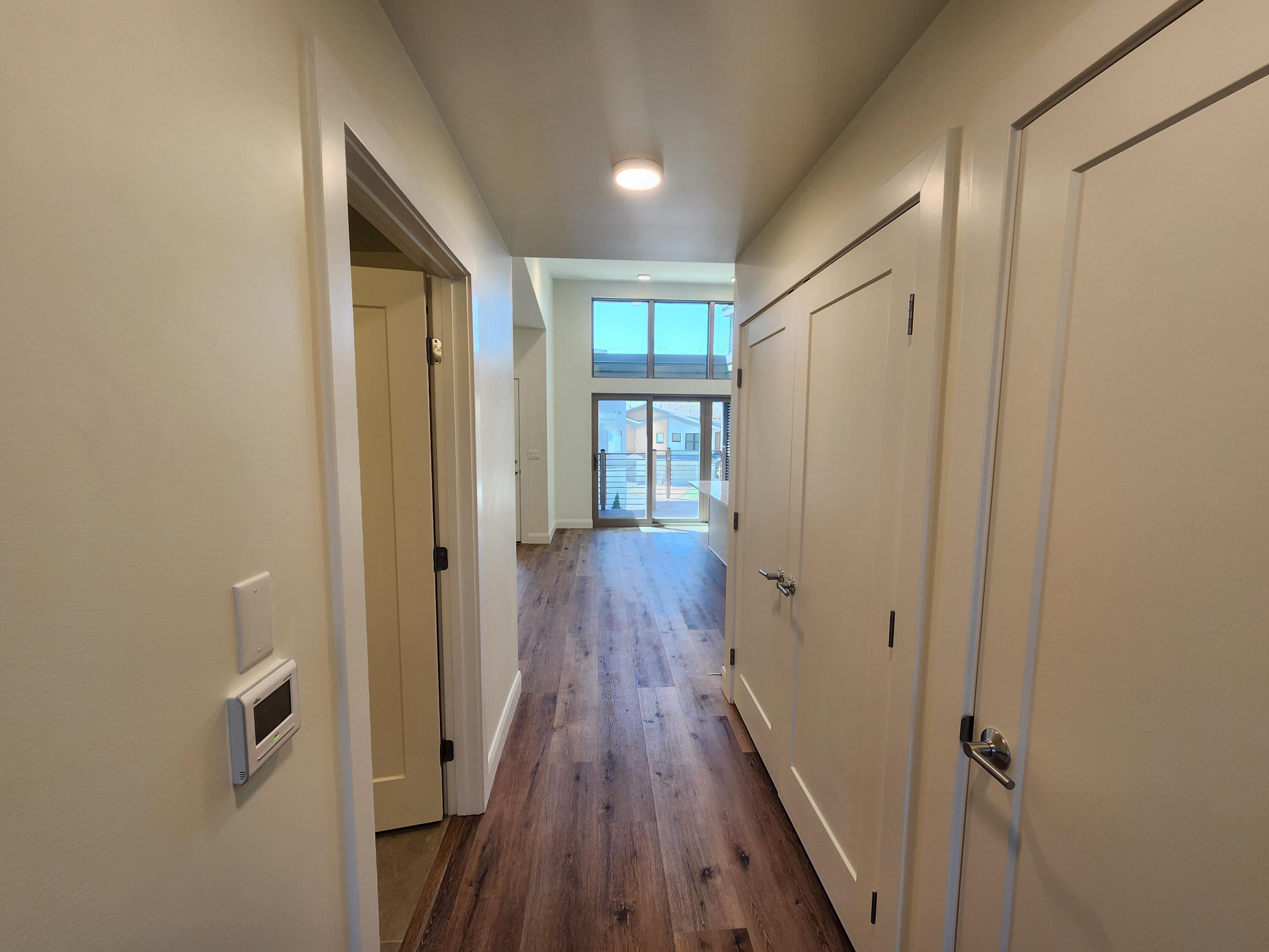 205 Jasper Place, Unit 203 Ridgway, CO 81432 - Photo 17 of 17 a view of a hallway with wooden floor and staircase