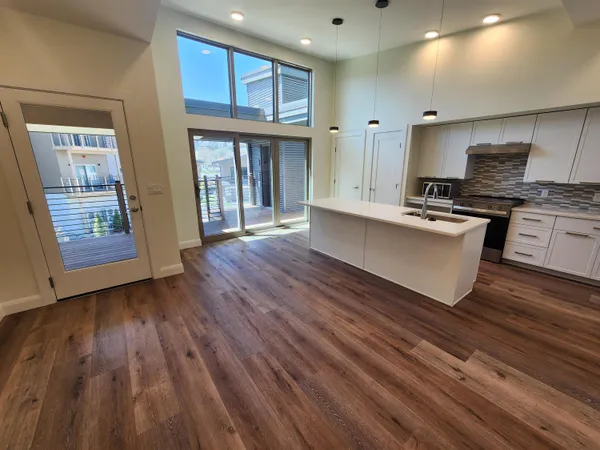 a kitchen with wooden floors and sink