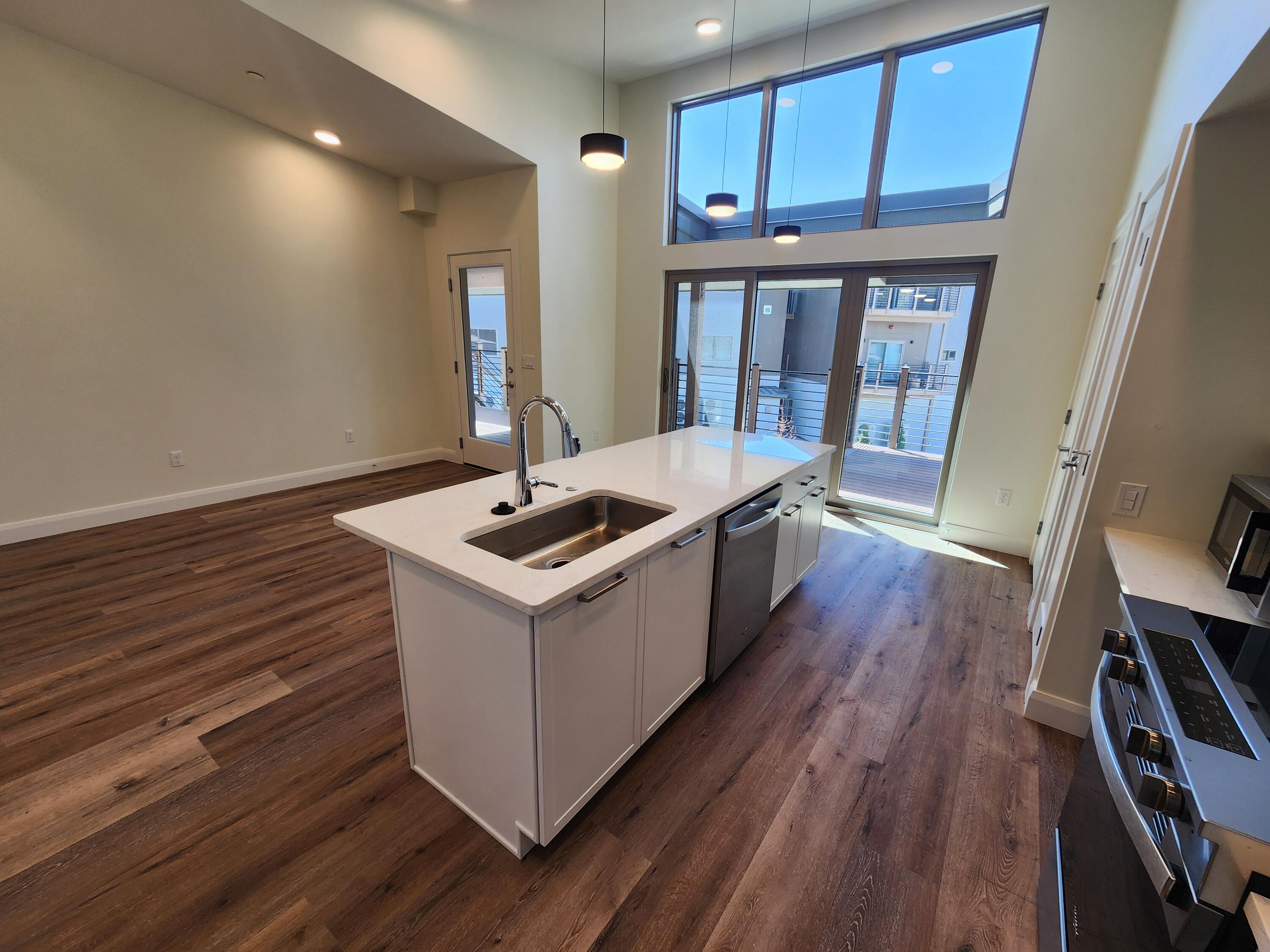 205 Jasper Place, Unit 203 Ridgway, CO 81432 - Photo 10 of 17 a kitchen with wooden floors and sink