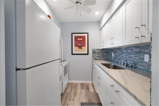 a kitchen with a refrigerator and a sink