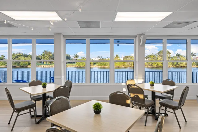 a dining room with furniture a large window and a table