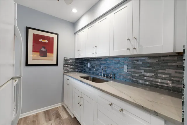 a bathroom with a sink and cabinets