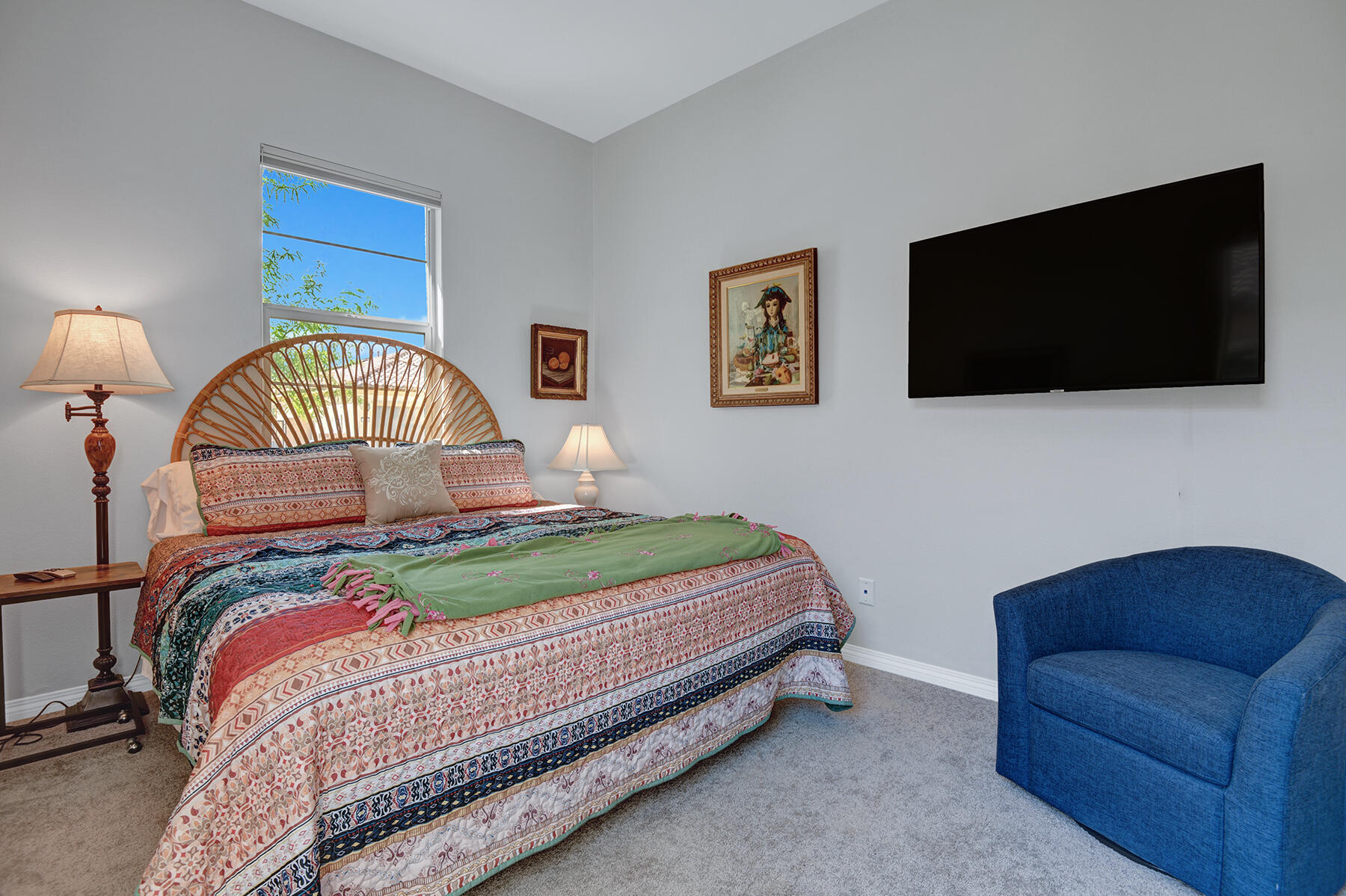 58 Claret Road Rancho Mirage, CA 92270 - Photo 13 of 33 a bedroom with a bed a flat screen tv and a chandelier